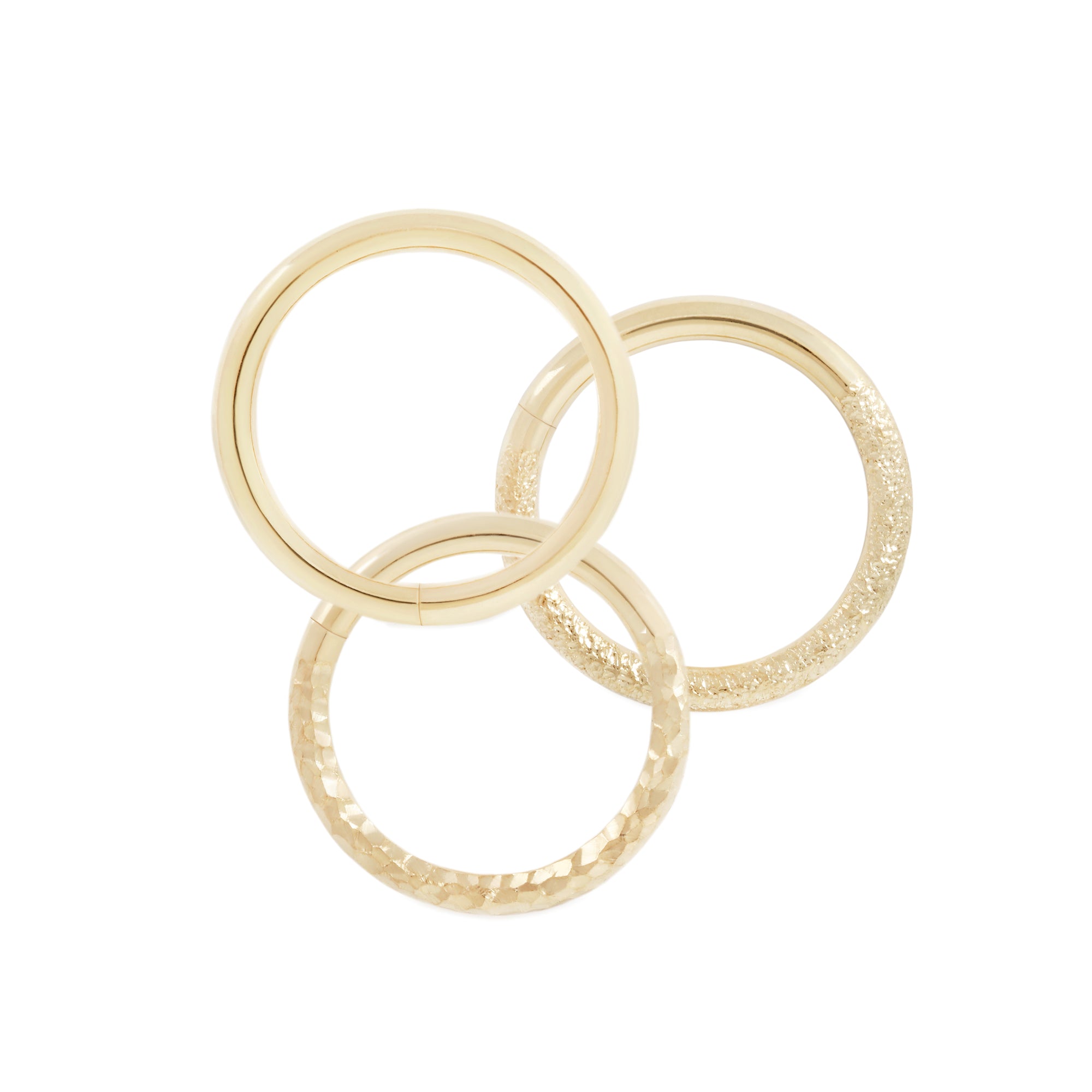 18 karat yellow gold seam rings, shown in high polish, stippled texture and hammered texture