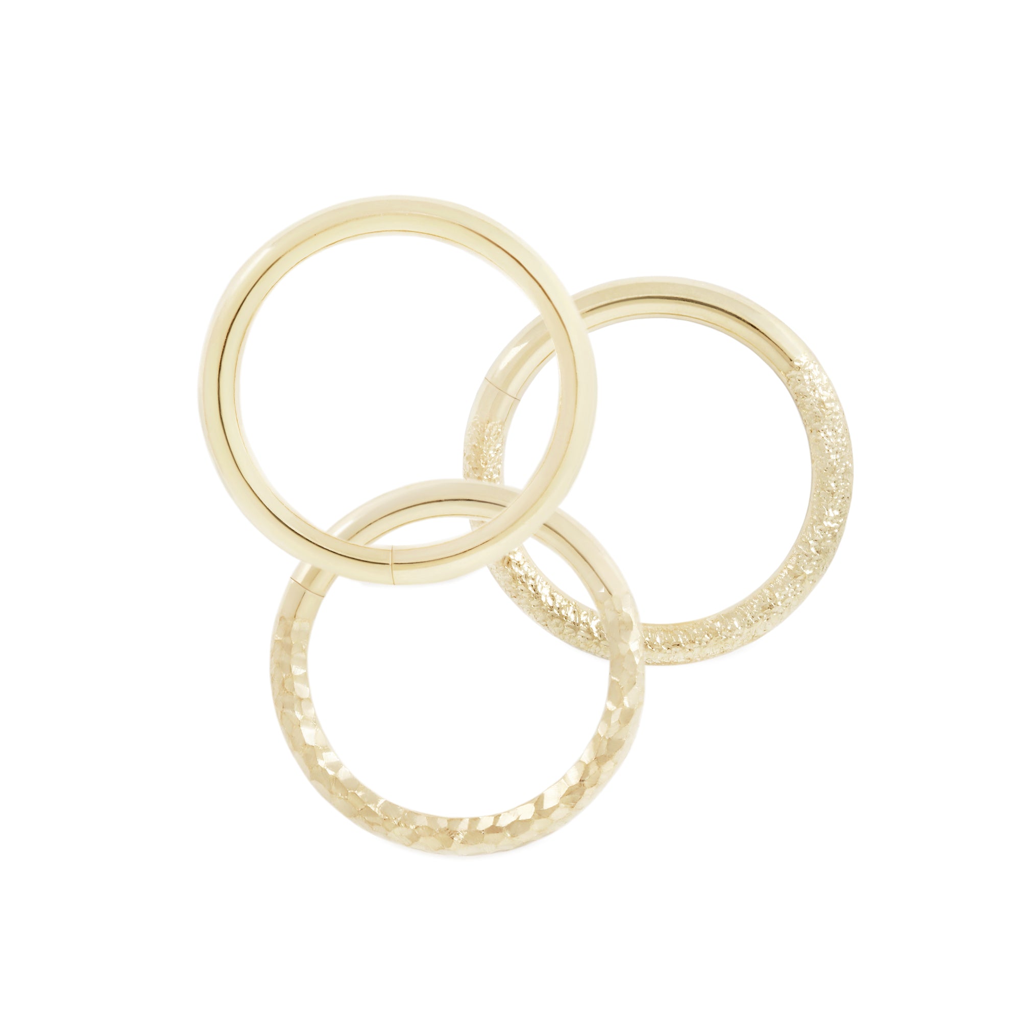 14 karat yellow gold seam rings, shown in high polish, stippled texture and hammered texture