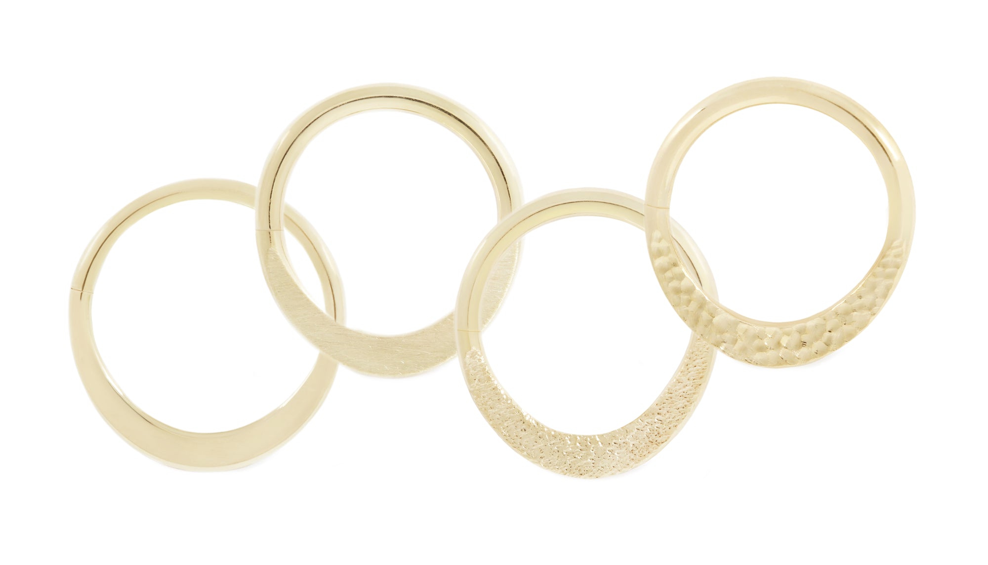 14 karat yellow gold smashed seam rings, shown in high polish, brushed texture, stippled texture and hammered texture