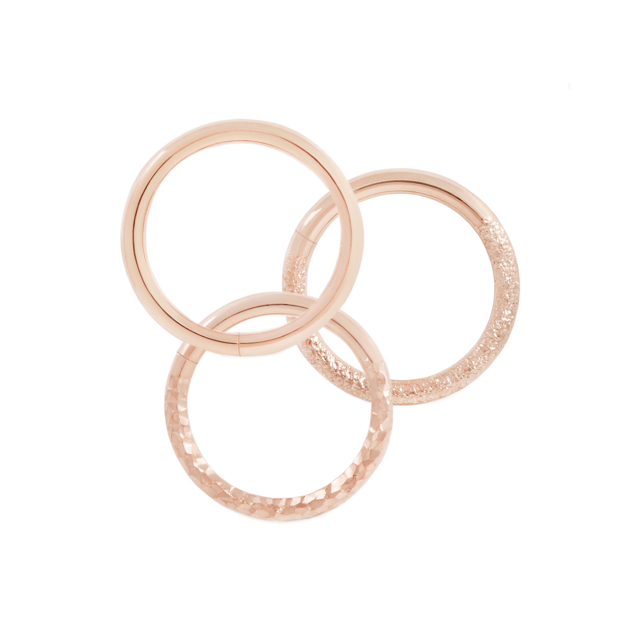 14 karat rose gold seam rings, shown in high polish, stippled texture and hammered texture