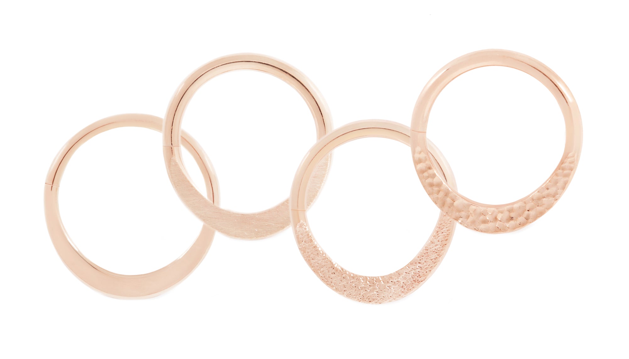 14 karat rose gold smashed seam rings, shown in high polish, brushed texture, stippled texture and hammered texture